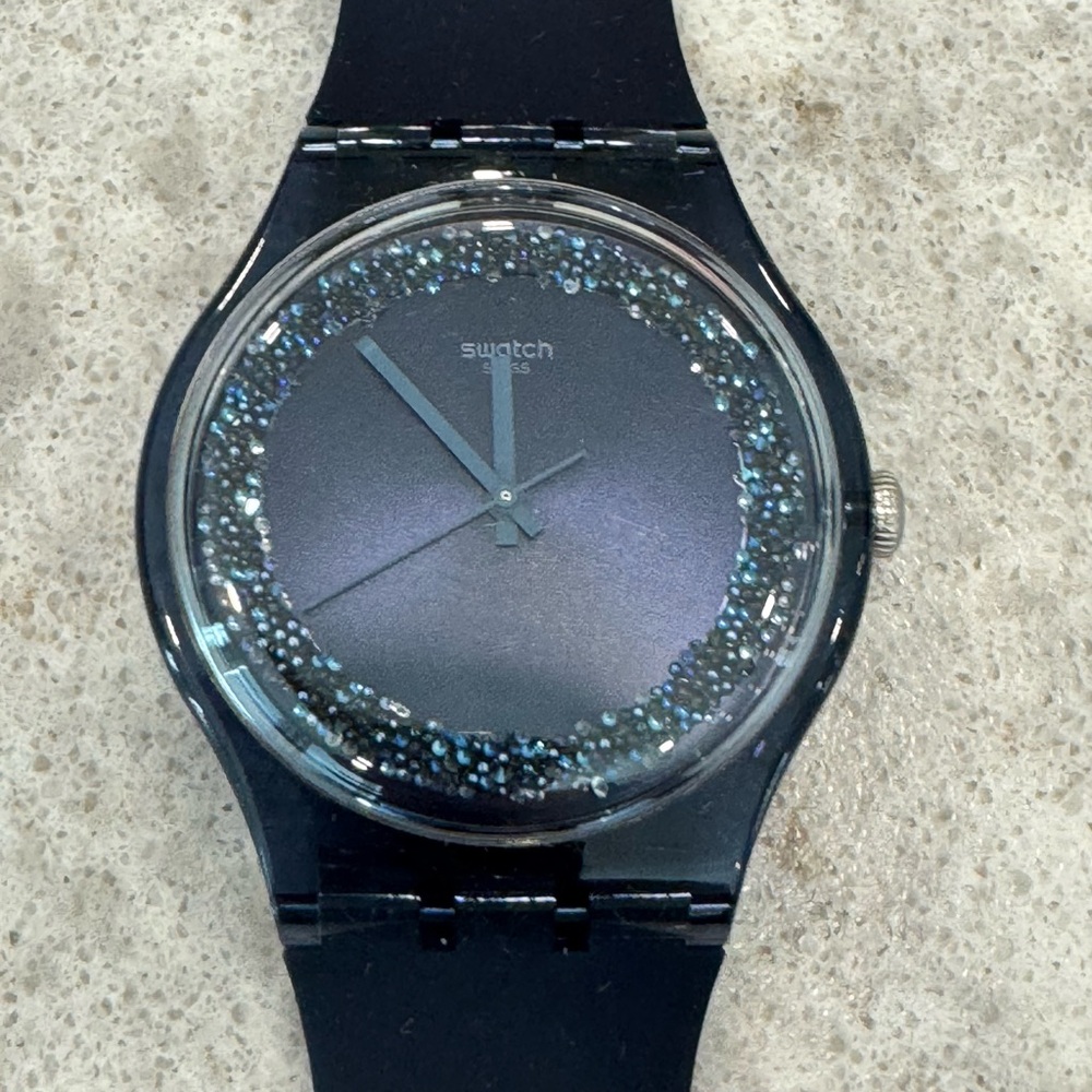 SWATCH watch - blue watchband with blue iridescent face.